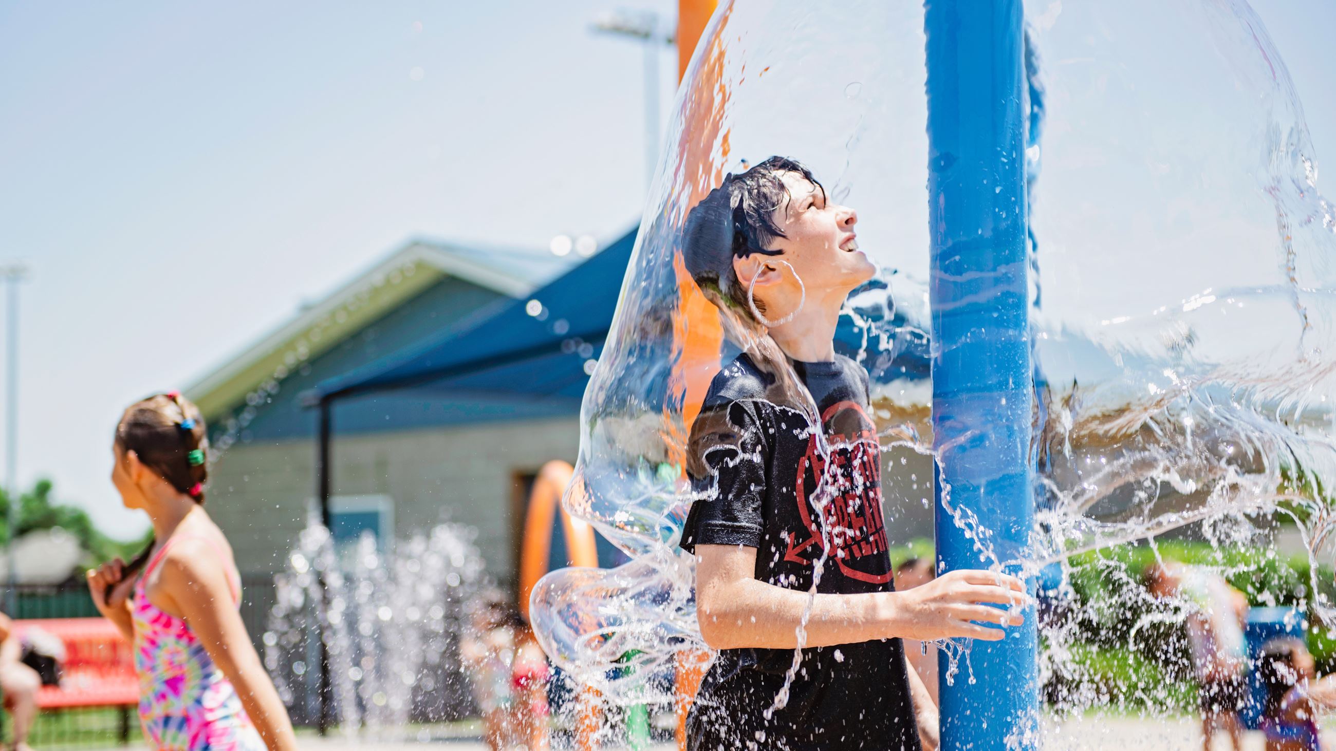 child playing at a splash pad