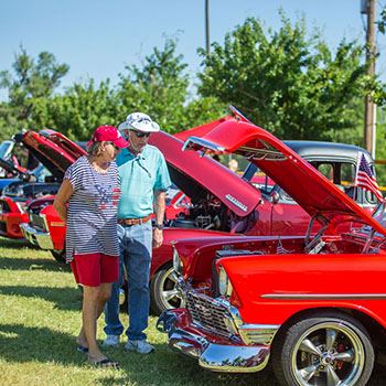 Couple Looks at Classic Cars at Freedom Fest