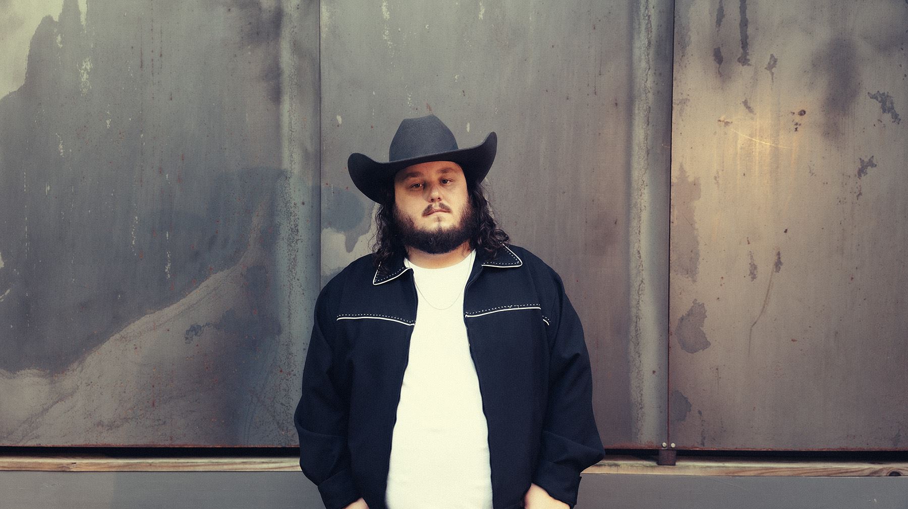 Photo of Tanner Usrey against an industrial wall